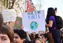 person holding there is no planet b poster